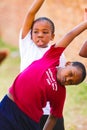 Diverse African Primary School children doing physical exercise PT lesson