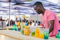 Diverse African vendor serving cocktail drinks at outdoor festival