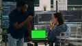 Diverse app developers working with greenscreen on laptop Royalty Free Stock Photo