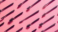 Diverse array of mascaras brush on pink background