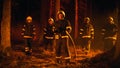 Diverse Brigade of Five Professional Firefighters Posing and Looking at Camera in a Forest Fire Royalty Free Stock Photo