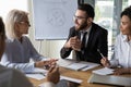 Diverse business partners discussing project, mature leader holding briefing Royalty Free Stock Photo