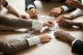 Diverse business people helping in assembling puzzle, teamwork s Royalty Free Stock Photo