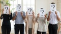 Diverse business people hiding faces behind papers with question marks Royalty Free Stock Photo