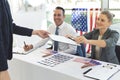 Diverse business people sat next to desk and smiling to applicant