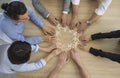 Diverse business people team group join puzzle pieces sit at desk view from top Royalty Free Stock Photo