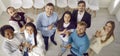 Multiethnic team of happy young business people standing in office, smiling and applauding Royalty Free Stock Photo