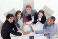 A diverse business team holding a terrestrial glob Royalty Free Stock Photo