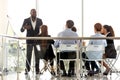 Diverse business team listening presentation of african coach at training Royalty Free Stock Photo