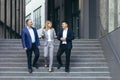 Diverse business team man and woman walking together on stairs outside office building Royalty Free Stock Photo