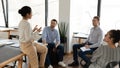 Diverse business team sitting in circle in office and talking Royalty Free Stock Photo