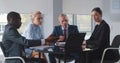 Diverse business team working in modern workplace office with laptop and documents on table. Royalty Free Stock Photo