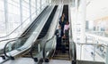 Diverse business travellers coming down an escalator Royalty Free Stock Photo