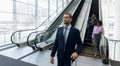 Diverse business travellers leaving an escalator Royalty Free Stock Photo