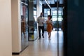 Diverse businessman and businesswoman wearing face masks checking documents in office