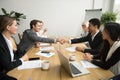 Diverse businessmen shaking hands after signing contracts at gro