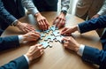 Diverse businesspeople collaborate in team-building jigsaw puzzle activity. Hands assemble puzzle pieces, unity, synergy in