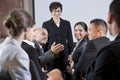 Diverse businesspeople conversing, woman at front Royalty Free Stock Photo