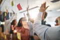 Diverse businesspeople high fiving after brainstorming together Royalty Free Stock Photo