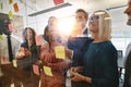 Diverse businesspeople laughing after brainstorming together in Royalty Free Stock Photo