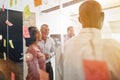 Diverse businesspeople laughing after an office brainstorming se Royalty Free Stock Photo