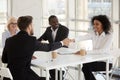 Diverse businesspeople shaking hands during meeting in office Royalty Free Stock Photo