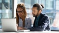 Diverse businesspeople work on laptop discuss project together Royalty Free Stock Photo