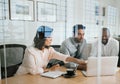 Diverse businesspeople working on a laptop inside of an office Royalty Free Stock Photo