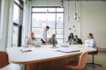 Diverse businesspeople working together around a boardroom table Royalty Free Stock Photo