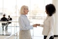 Diverse businesswomen shaking hands greeting each other Royalty Free Stock Photo