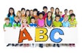 Diverse Cheerful Children Holding Letters