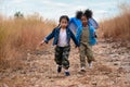 Diverse children of asian and african american girl having fun walking and playing together in natural park Royalty Free Stock Photo