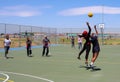 Diverse children playing Netball at school