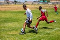 Diverse children playing soccer football at school