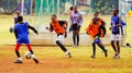 Diverse children playing soccer football at school