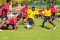 Diverse children playing soccer football at school