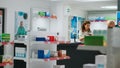 Diverse clients looking at pharmaceutical medicine on shelves
