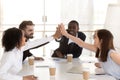 Diverse colleague giving high five, celebrating corporate success