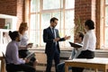 Diverse colleagues employees listening to mentor coach at meeting Royalty Free Stock Photo