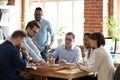 Diverse colleagues enjoy pizza having lunch break in office Royalty Free Stock Photo