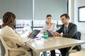 Diverse colleagues gather in brainstorm discuss statistics together. Group of people colleagues gather doing Brainstorming busines Royalty Free Stock Photo