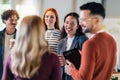 Diverse colleagues have fun at lunch break in office, smiling multiracial employees laugh and talk drinking coffee Royalty Free Stock Photo