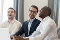 Diverse colleagues having fun during break, working on project together Royalty Free Stock Photo