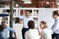 Diverse colleagues laughing engaged in teambuilding activity at Royalty Free Stock Photo