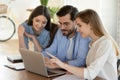 Diverse colleagues work together on laptop in office Royalty Free Stock Photo