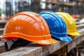 Diverse colored safety helmets at a construction site emphasize the importance of workplace safety Royalty Free Stock Photo