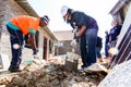 Diverse Community Outreach program mixing cement for building a small affordable house Royalty Free Stock Photo