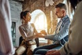 Diverse company members gather together to do team-building exercises. Woman and man at rehab groups holding hands show gratitude