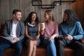 Diverse company of millennial teammates having informal meeting at cafe