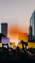 Diverse crowd protesting at sunset with colorful signs in urban environment Royalty Free Stock Photo